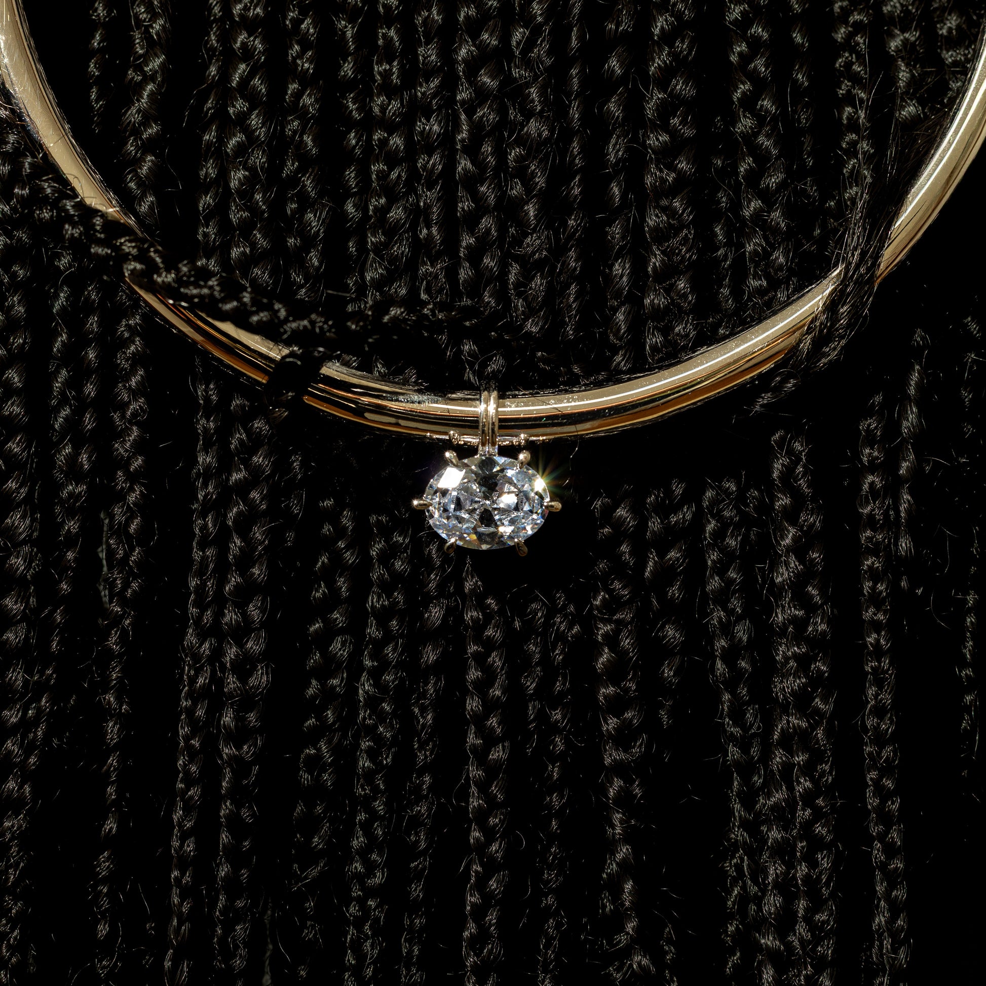 Necklace with a pendant on a black textured background